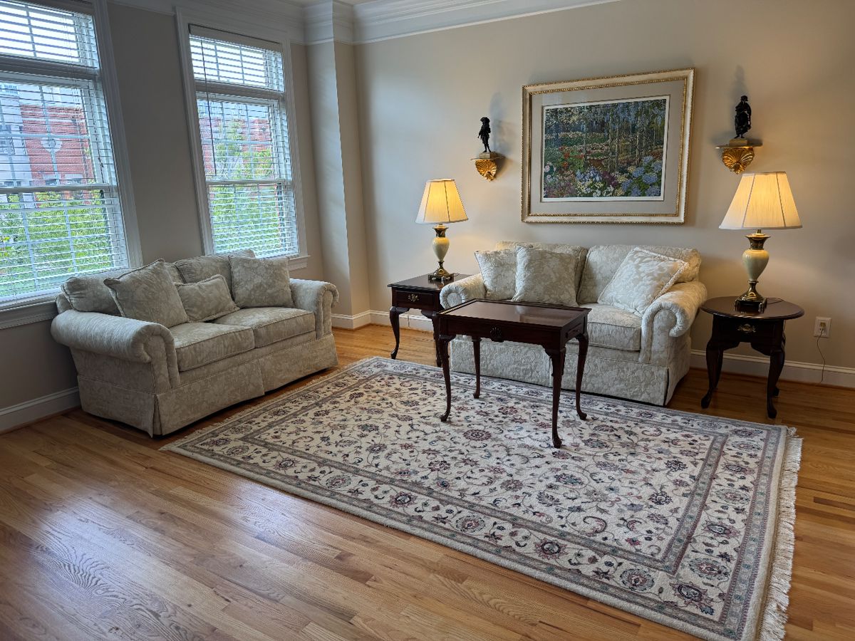 Home Elements Floral Motif Upholstered Cream Tone Loveseat (62"W x 35"D x 29-1/2"H / 2 Available) with Queen Anne Style Mahogany Tea Table (18"W x 28"D x 25"H) & Queen Anne Style 1 Drawer Side Table (27"D x 18"W x 23"H) with Stiffel Porcelain Body Table Lamp (2 Available) & Queen Anne Round Mahogany 1 Drawer Side Table (25"D x 21"W x 23"H) with Stiffel Porcelain Body Table Lamp (2 Available) with Framed Original Serigraph "Sunrise and Morning Glories" Autographed by John Powell / Edition 161/300 accented with Hand-Knotted Kashan Wool Pile Rug (71"W x 108"L)