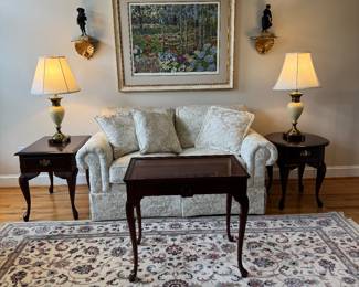 Home Elements Floral Motif Upholstered Cream Tone Loveseat (62"W x 35"D x 29-1/2"H / 2 Available) with Queen Anne Style Mahogany Tea Table (18"W x 28"D x 25"H) & Queen Anne Style 1 Drawer Side Table (27"D x 18"W x 23"H) with Stiffel Porcelain Body Table Lamp (2 Available) & Queen Anne Round Mahogany 1 Drawer Side Table (25"D x 21"W x 23"H) with Stiffel Porcelain Body Table Lamp (2 Available) with Framed Original Serigraph "Sunrise and Morning Glories" Autographed by John Powell / Edition 161/300