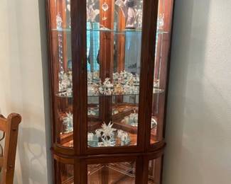 Beautiful 7' lighted corner cabinet w/ rounded sides.