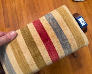 Rocking ottoman with wood on one side and velveteen stripes on the other