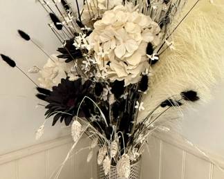 Black and white floral display in silver vase