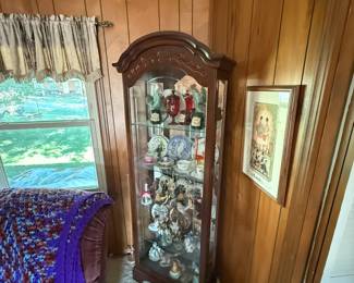 curio full of trinkets and decor