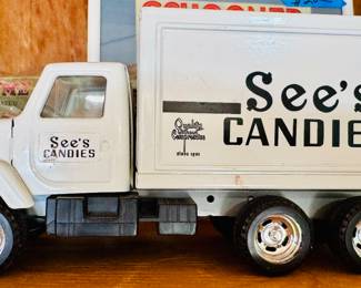 Vintage white See’s Candies delivery truck collectible. Marked ©1987 See’s Candy Shops, Inc. on the side. Made of plastic with chrome-look wheels and a boxy 1980s-style cab.