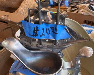 Cast metal sailboat with a pewter finish. Mounted on a base, possible souvenir or decorative piece.
