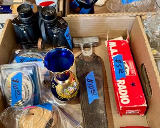 Includes cobalt blue mini vase with gold floral trim, vintage binoculars, harmonica, “The Master Key” game, and other assorted collectibles.
