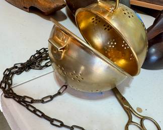 Antique or vintage brass balance-ball style strainer or incense burner with perforated bowl halves and attached chain. Includes metal tongs or scissors-like grabbers.