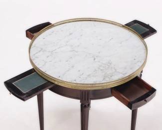 French ebonized mahogany marble top bouillotte table having a bronze gallery, pull out slides and two drawers C 1940. 25.75"Diameter x 28"H