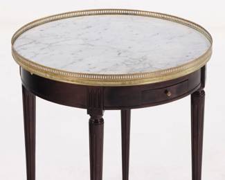 French ebonized mahogany marble top bouillotte table having a bronze gallery, pull out slides and two drawers C 1940. 25.75"Diameter x 28"H