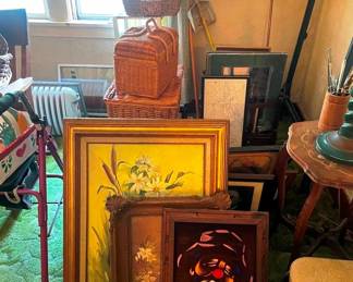 A large collection of framed prints and empty frames