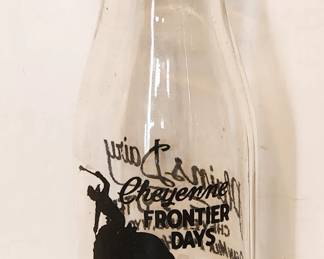 Milk bottle from Plains Dairy commemorating the  Cheyenne Frontier Days rodeo