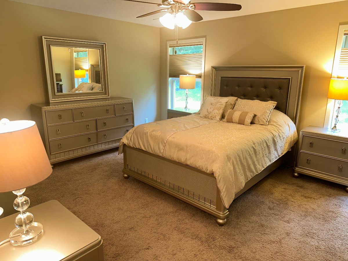NEW 8 PIECE LUXURY QUEEN QUALITY BEDROOM SET.  PLATINUM FINISH.  SEE OTHER PHOTOS.  SET INCLUDES DRESSER WITH MATCHING MIRROR, CHEST, QUEEN SIZE PILLOW TOP MATRESS WITH MATCHING HEADBOARD, FOOTBOARD AND SIDE RAILS, NIGHTSTANDS AND VANITY WITH MIRROR AND BENCH.  LAMPS AND DESIGNER COMFORTER INCLUDED.