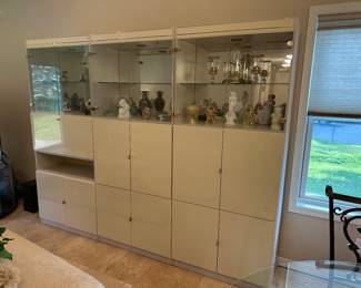 MODERN OFF WHITE 3 PIECE CURIO CABINET WITH LIGHTED MIRRORED BACK, HAS FOLD OUT SHELF FOR DESK OR LAPTOP. GREAT STORAGE AND DISPLAY PIECE.
