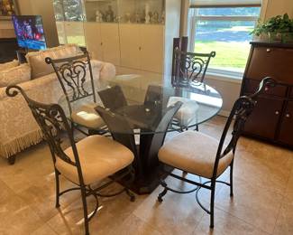 NEW 54" ROUND GLASS TOP TABLE WITH DARK WOODEN BASE INCLUDES 4 MATCHING CHAIRS WITH PLUSH SEAT CUSIONS.