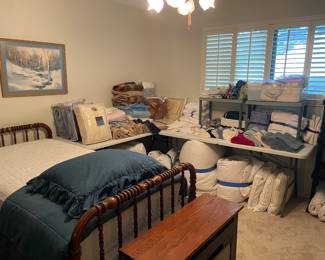 Packed room filled with linens, comforters and quilts. Vintage Twin Bed 