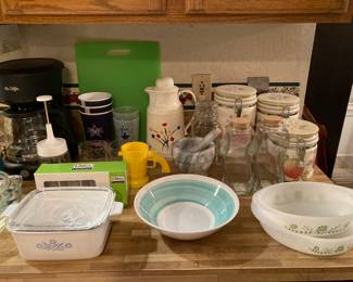 kitchenwares, including Corning Cornflower covered dish, vintage Glasbake, mortar and pestle, and canister jars set