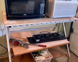 small ac unit, microwave, and rolling workstation