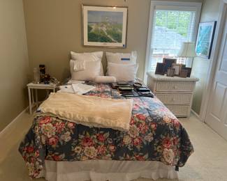 Queen bed, linens, wicker chest, wicker table, art posters