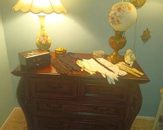 4 drawer chest with antique gloves and lamps