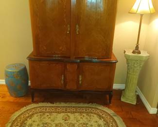 Antique cabinet with inlaid doors and glass shelves