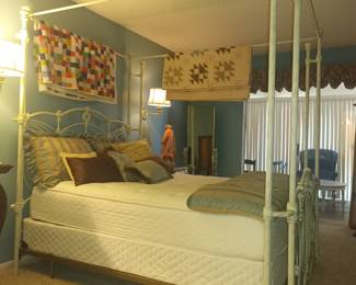 Heavy iron canopy bed and quilts