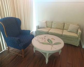 Highback chair, lowback couch and round painted coffee table