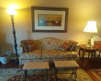 Floral couch, floor lamp and foot benches