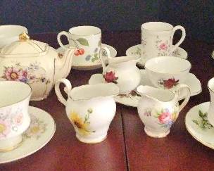 Adorable Assortment of Tea Cups, Saucers. Creamer And A Tea Pot