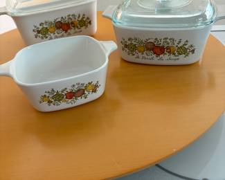 vintage corningware is on a large lazy susan.