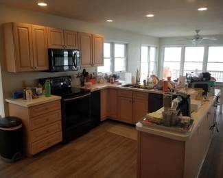 Kitchen cabinetry: Designer by Medallion. Large U-shaped kitchen with a pantry wall