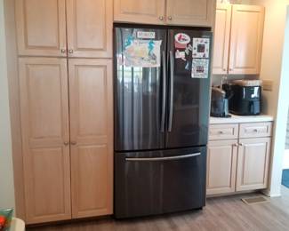 Kitchen cabinetry: Designer by Medallion. Pantry wall. Samsung refrigerator