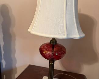 One of a pair of vintage cranberry glass lamps