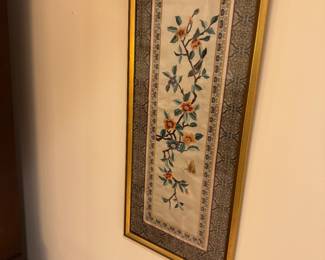 One of a pair of framed needlework