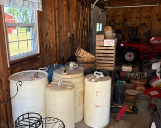 Crates, water barrels, and plant stands