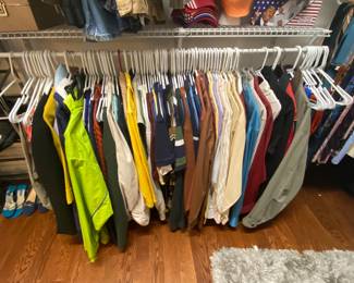 Closet loaded with men’s clothing.