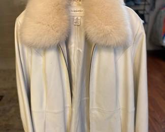 Lamb skin coat with fox fur collar.