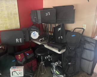 Many music stands 
drum and symbol bags for storage and travel bags, 