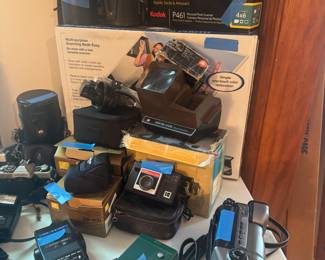 Multi cameras 
Cannon, vintage , photo items, lenses 
Nixon flash’s new in box not uses 
Kodak camera , panta viewer old camera 