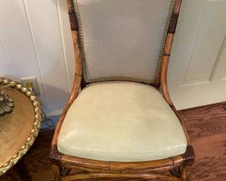 One of a pair burnt bamboo side chairs with leather seats 