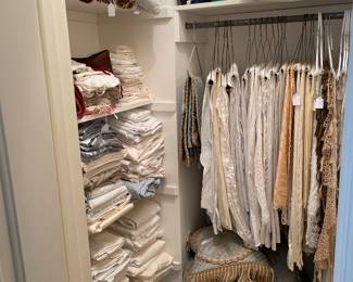 Closet full of vintage linens , tablecloths and sheets and pillows 