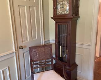 Mahogany grandfather clock with English mahogany armchair with cream leather seat