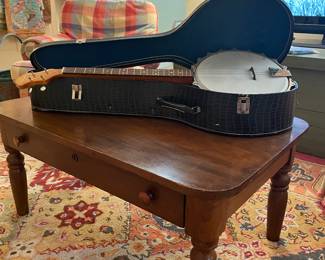 Wonderful walnut coffee table with vintage Frames banjo in alligator case