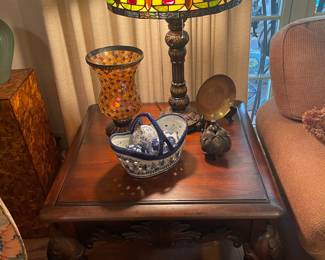 One of a pair of stained glass lamps on a carved mahogany end table 