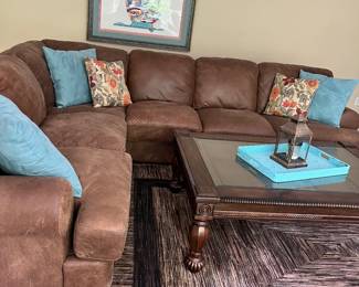 Brushed suede sectional, area rug and coffee table