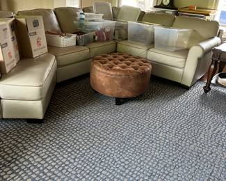 Better picture will come - Creamy Leather Sectional, Tufted foot stool, blue area rug