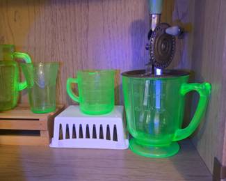 Vaseline glass measuring cup and hand mixer.
