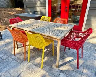 1 WeatheredTeakDiningTablew6BrightMoldedPlasticChairs