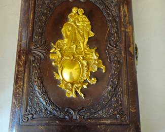 Leather photo album with ornate center brass medallion and elaborate tooling. Clasp is intact.