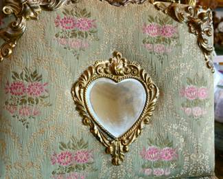 Victorian photograph album with heart-shape mirror medallion.