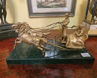 Gilt bronze troika pulled by the traditional three horses, mounted on a beautiful malachite base. Unsigned.