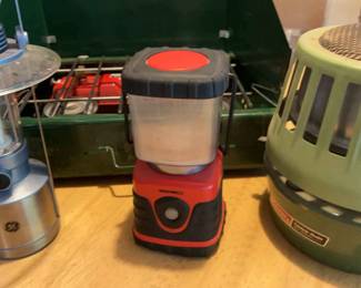 Coleman Stove And Heater, Two Lanterns and Three Chairs